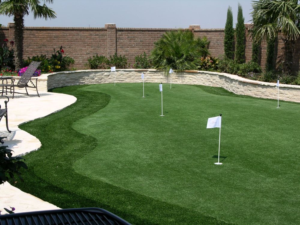 a backyard putting green against a wall